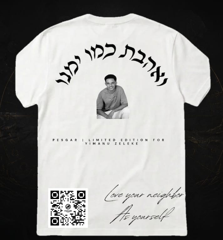 White t-shirt with black text and a QR code on a dark background